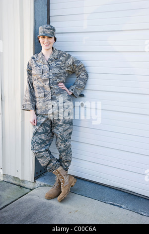 Young woman standing in army combat uniform Stock Photo