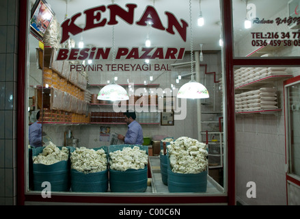 A cheesemonger and merchant working in a cheese store in the old market bazaar in the city of Van, in the eastern Anatolia region of southeast Turkey. Stock Photo