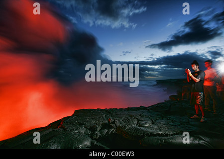 Tourists watching the Kilauea Lava flow on Hawaii's big island. Stock Photo