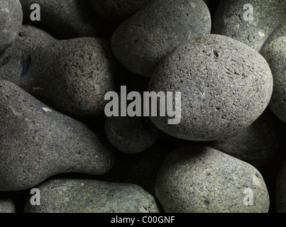 granite pebbles round and smooth forming an abstract background Stock Photo
