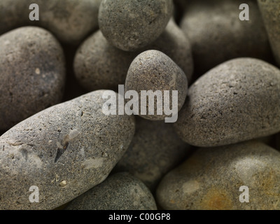 granite pebbles round and smooth forming an abstract background Stock Photo