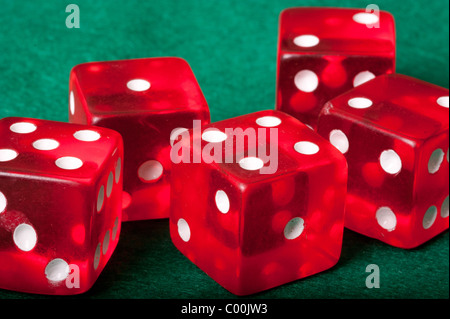 Five red casino dices on green background Stock Photo