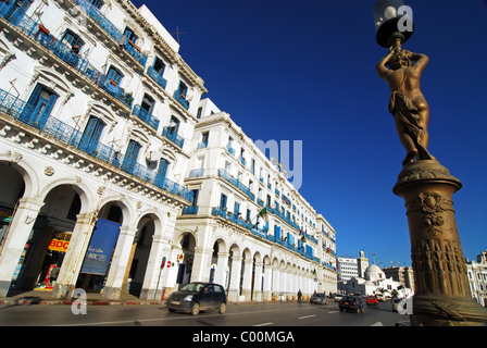 Algeria, Alger, low angle view of car moving on street by building with lamppost in foreground Stock Photo