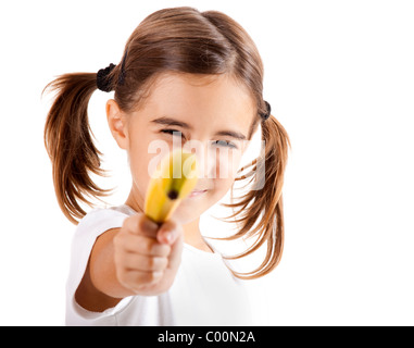 Little girl isolated on white pretending is shoot with a banana Stock Photo