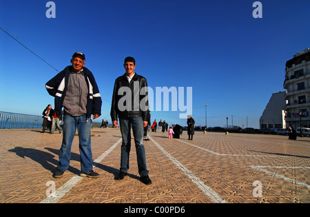 Algeria, Alger, low angle view of men standing on tiled floor with people in background against sky Stock Photo