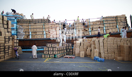 A traditional dhow being loaded in the dhow wharfage in The Creek, Dubai, UAE Stock Photo