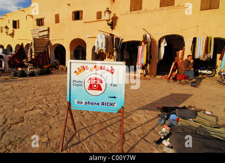 Algeria, Ghardaia, commercial sign displayed at market with seller selling clothes at the market place Stock Photo