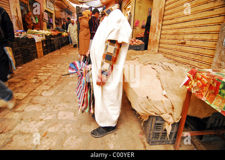 Algeria. Ghardaia, view of marketplace with vegetable sellers, man selling plastic bags in the foreground Stock Photo