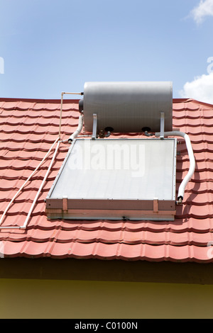 Solar water heater sits on the roof of a home in Manchester, Jamaica. Stock Photo
