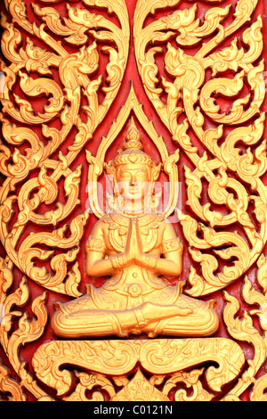 raditional thai style art carving at the door of temple Stock Photo