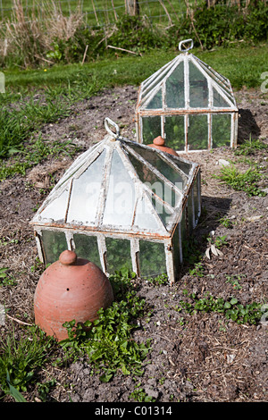 Traditional garden cloches and forcing pot in garden of Gilbert White's house Selborne Hampshire England UK Stock Photo