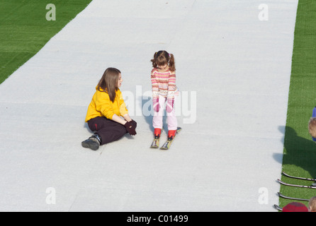 Child learning to Ski on a dry Ski slope in Plymouth Devon England Stock Photo