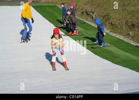 A child learns to ski on a dry Ski slope in Plymouth Devon England Stock Photo