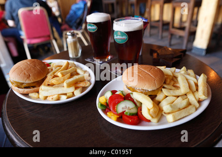 Burger with fries and Smithwick's beer in a pub in Shannonbridge, County Offaly, Leinster, Republic of Ireland, Europe Stock Photo