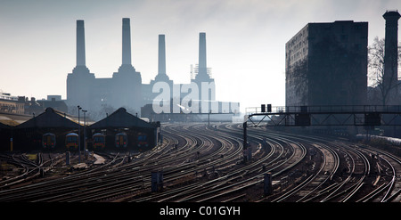 London Victoria Station railway sidings looking towards Battersea Power Station across parallel rail tracks glinting in the sun Stock Photo