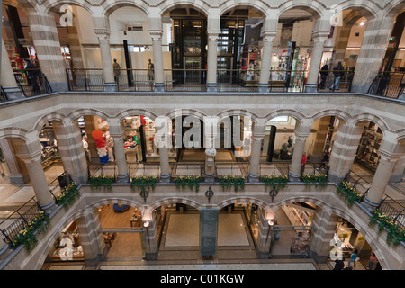 Arcades in the inner courtyard of Magna Plaza shopping centre in the former building of the Main Post Office Stock Photo