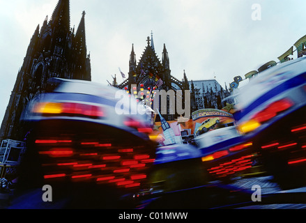 Amusement ride in front of Cologne Cathedral, Cologne, North Rhine-Westphalia, Germany, Europe Stock Photo