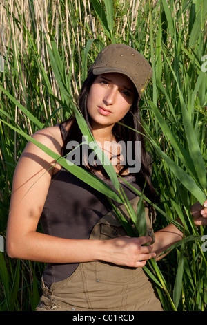 Young woman standing amongst the reeds Stock Photo