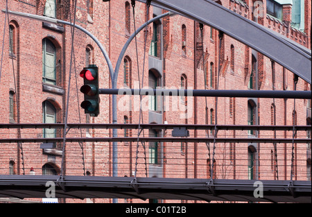 Pedestrian bridge with traffic lights in the Speicherstadt historic warehouse district in Hamburg, Germany, Europe Stock Photo