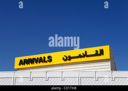 A sign says 'Arrivals' in English and Arabic. Stock Photo