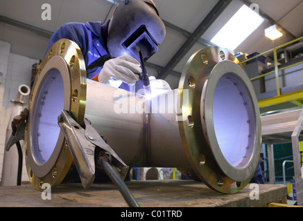 Welder working on pipe junction Stock Photo