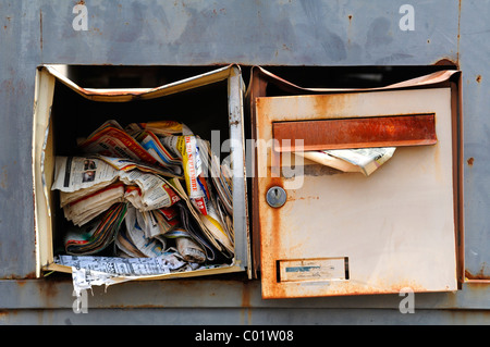 Damaged mailboxes full of advertising, Guémar, Alsace, France, Europe Stock Photo