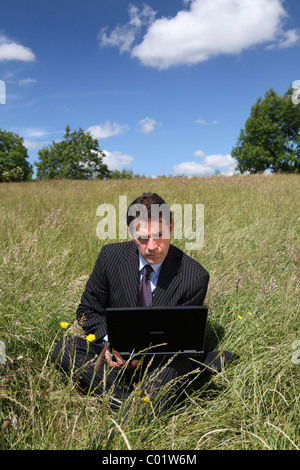Businessman working remotely in rural location Stock Photo