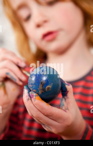 Easter, child painting an easter egg Stock Photo