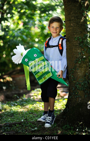 First day at school, boy with Schultuete, large cornet of cardboard filled with sweets and little presents given to children in Stock Photo