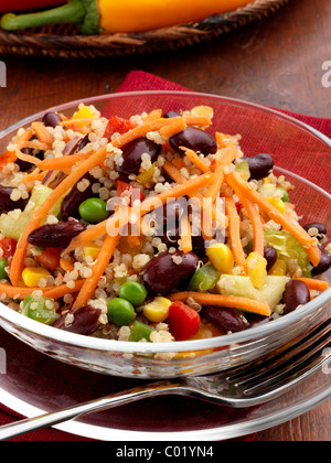 Individual portion of quinoa salad with peas sweetcorn carrots red peppers red kidney beans vegetarian meal Stock Photo