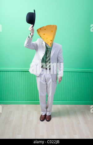 Man in suit wearing cheese head tipping hat Stock Photo