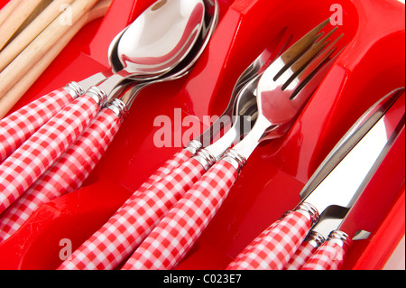 Cheerful red checkered cutlery in plastic box Stock Photo