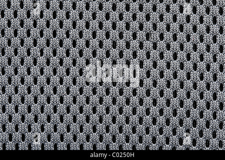 macro of woven black mesh textile background texture with regular holes Stock Photo