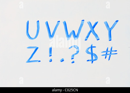 the letters U V W X Y Z and punctuation in blue marker on a dry erase white board Stock Photo