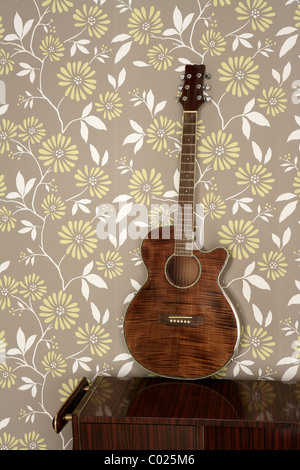 acoustic guitar retro on vintage 60s wallpaper wooden furniture Stock Photo