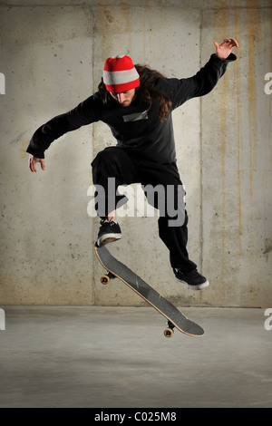 Skateboarder jumping over grunge background Stock Photo