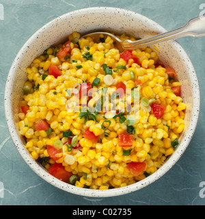 corn relish in bowl with spoon Stock Photo