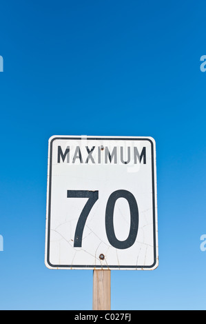A traffic sign with a cracked surface reads Maximum 70 Stock Photo