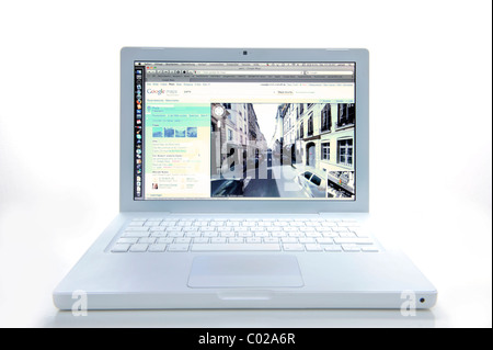 Notebook screen displaying city image on Google Street View Stock Photo
