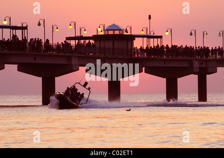 The pier in sunset and a speedboat, Miedzyzdroje, Poland, Europe Stock Photo