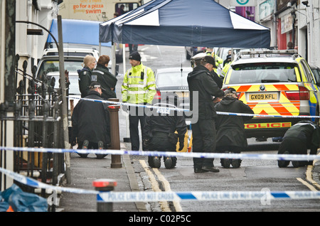 Police investigate the crime scene where police shot dead a suspect Stock Photo