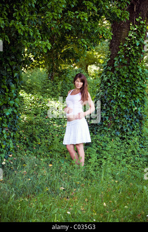 pregnant woman in a park Stock Photo