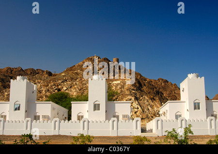 New single-family houses below an ancient fort on the outskirts of Muscat, Sultanate of Oman, Middle East Stock Photo
