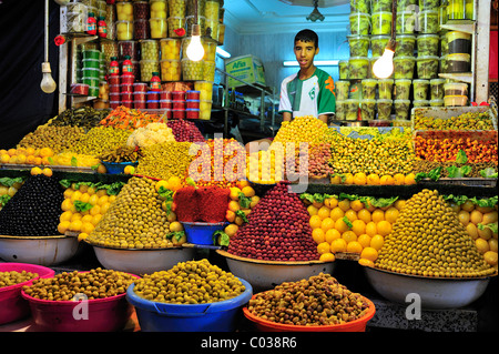 A young trader selling pickled olives and lemons at a stall in the souk, bazaar, Meknes, Morocco, Africa Stock Photo