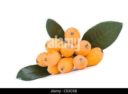 Fresh loquat (Eriobotrya) fruits and green leaves Stock Photo