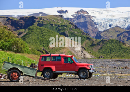 Red Jeep in a river bed near the Eyjafjallajoekull glacier, Borsmoerk, Iceland, Europe Stock Photo