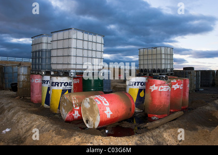 Oil barrels at construction site for heavy equipment maintenance Stock Photo