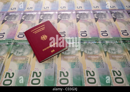 Passport of the Federal Republic of Germany on various Canadian dollar bills Stock Photo