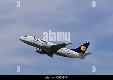 Boeing 737-500 airline from Lufthansa climbing in front of cirrostratus clouds Stock Photo