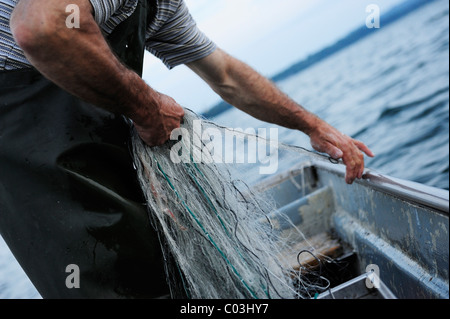 The fisherman Johann Strobl casting for fish on Lake Starnberg, Fuenfseenland area, Upper Bavaria, Bavaria, Germany, Europe Stock Photo